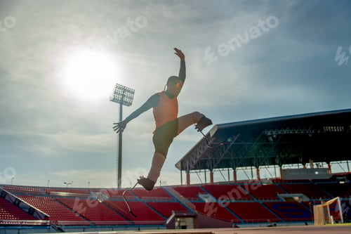 Preview: Front view of sport man athlete prosthesis legs jump up in front of sun light in the afternoon