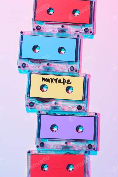 Preview: top view of arranged colorful audio cassettes with mixtape lettering on purple background
