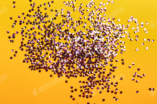 Preview: Shiny bright violet glitter on yellow background, flat lay