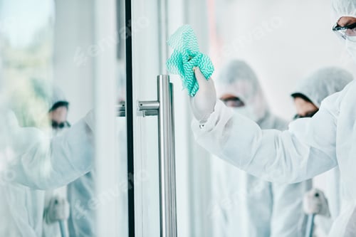 Preview: Worker in Hazmat Suit Cleaning Glass Surface