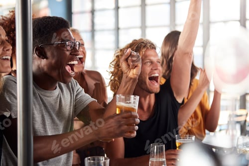 Preview: Group Of Male And Female Friends Celebrating Whilst Watching Game On Screen In Sports Bar