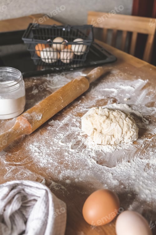 Preview: Girl prepares dough for bread.Homemade baking.Dough and hands close-up,ingredients for dough
