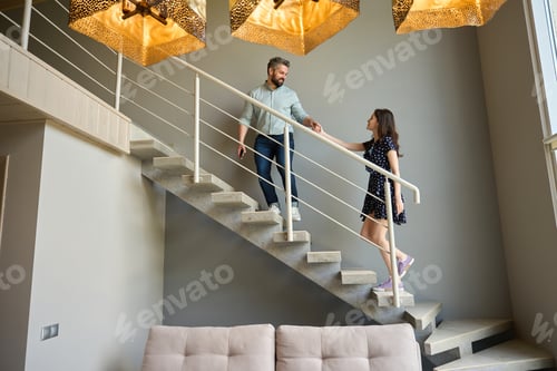 Aperçu: Husband and wife climb up the stairs in the house