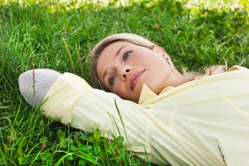 Preview: Germany, Cologne, Woman lying on grass
