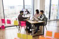 Preview: Team brainstorming session in modern office with video conference