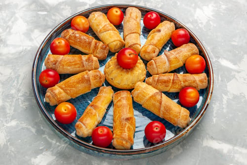 Preview: front view delicious sweet bagels with sour plums on light white desk pastry cake bake biscuit sweet