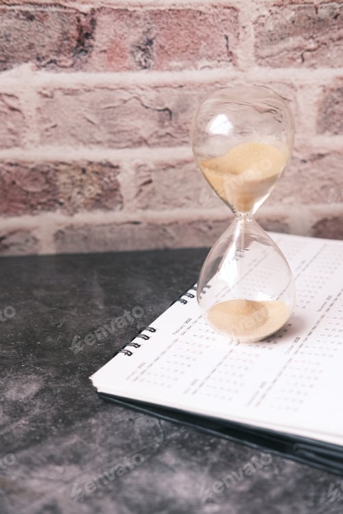 Preview: hourglass on a calendar, and flowing through the bulb of sandglass