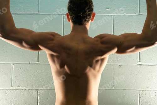 Preview: rear view of man flexing