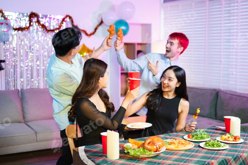 Preview: A fun party moment as young friends toast with red cups and laugh while one playfully holds