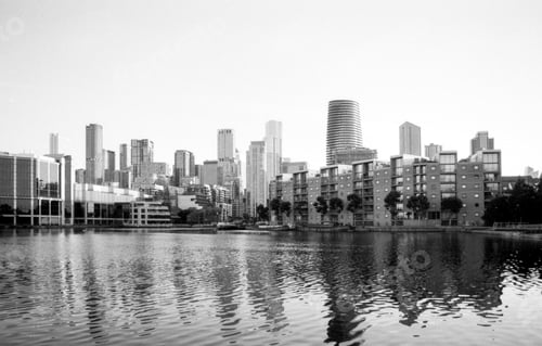 Preview: Modern skyline reflecting on calm water in canary wharf, london, uk