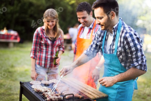Preview: Happy young and joyful friends enjoying barbecue party