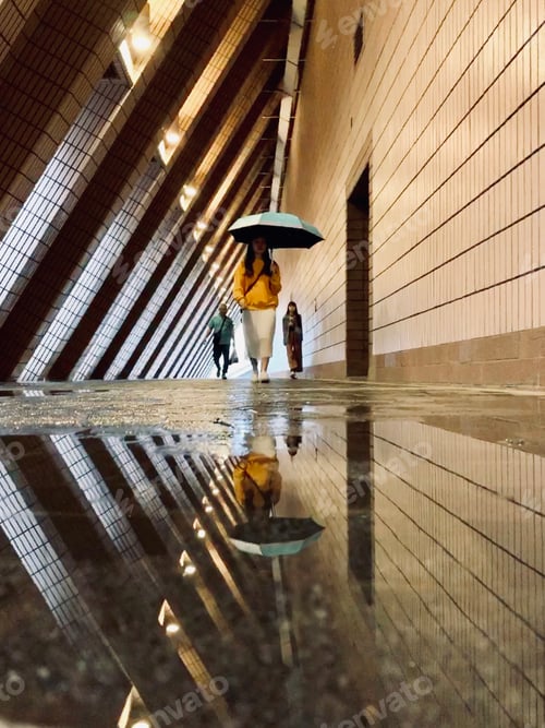 Preview: Reflection of a woman with an umbrella.