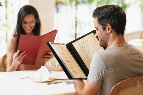 Preview: So many delicious things to choose from. A happy young couple on a date at a fancy restaurant.