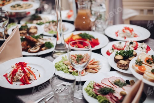 Preview: Banquet table served with various cold snacks and salads