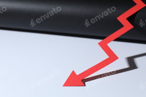 Preview: One red paper arrow on color background, closeup. Space for text