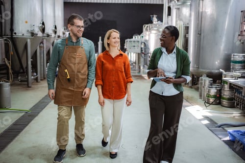 Preview: Colleagues walking through brewery discussing production process