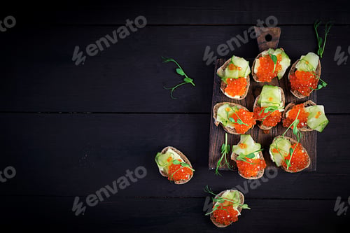 Preview: Canape with salmon red caviar. Sandwich for lunch. Delicious food. Top view, overhead