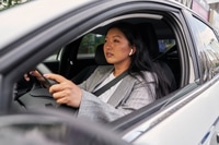 Preview: Chinese woman using earphones while driving a car