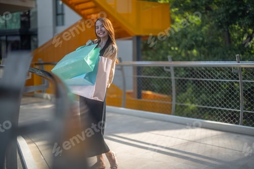 Preview: Stylish lady strolls downtown, explores new stores, and smiles while enjoying chic weekend shopping
