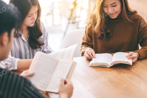 Preview: Group of people sitting and enjoyed reading book together on wooden table