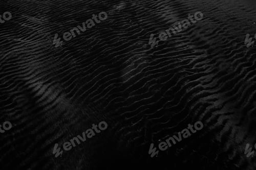 Preview: Closeup shot of wet black sand perfect for using a neutral background