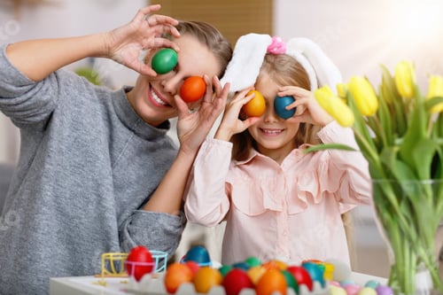 Preview: Mother and daughter painting Easter eggs at home