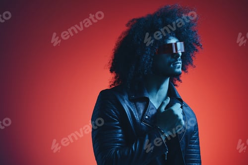 Preview: Portrait of fashion man with curly hair on red background with stylish glasses, multicultural