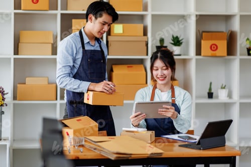 Preview: Startup small business SME. Two Young Asian business entrepreneurs using laptop computer check onlin
