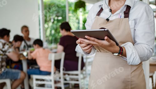 Preview: Service waiter servicing the customer at cash point in cafe.