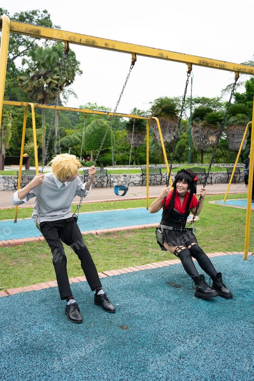 Preview: Cosplayers having fun on swings in a park