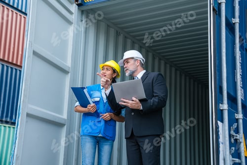 Preview: Container yard manager with safety hat talking to foreman about the goods inside the warehouse.