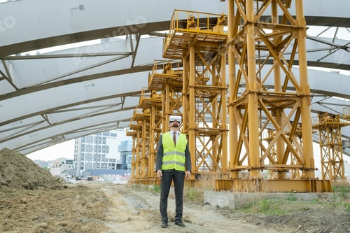 Preview: Young builder in vr headset standing on construction site