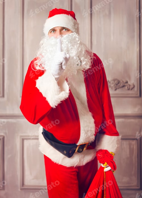 Preview: Photo of happy Santa Claus with big bag of presents looking at camera