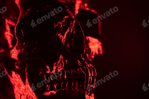 Preview: Ancient human skull head close-up. Neon red light. Spooky sinister. Glamour, disco,halloween concept