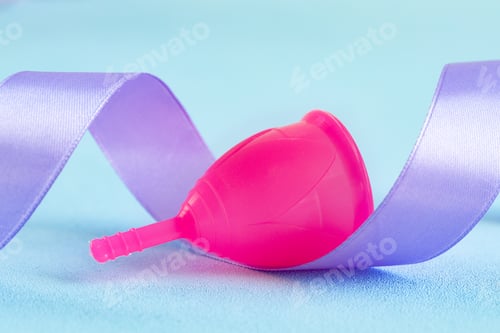 Preview: Lilac ribbon and menstrual cup close up