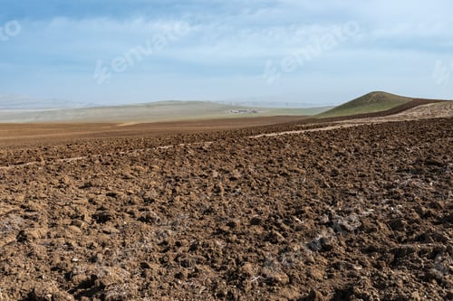 Preview: Plowed farm field in mountain valley