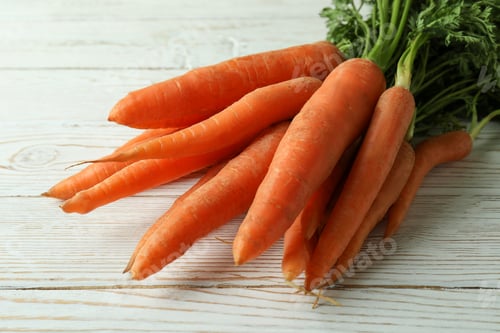 Preview: Heap of fresh carrot on white wooden table