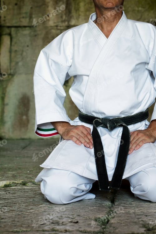 Preview: Black Belt Karate Man Sit On A Position To Start Or Finish Practicing