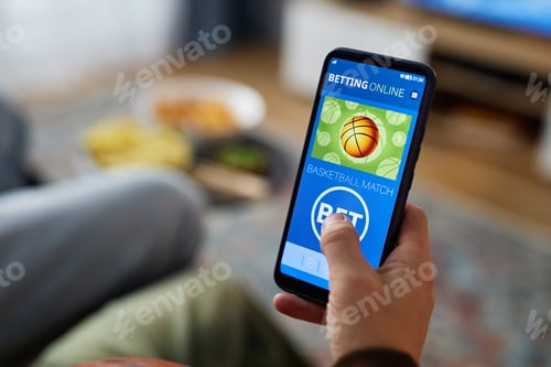 Preview: Close Up of Phone in Hand with Basketball Match Betting App Interface