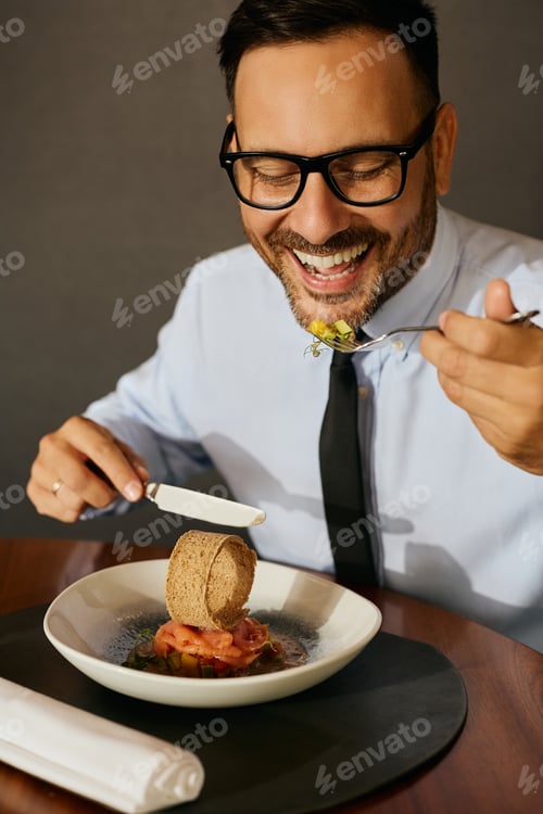Preview: Happy businessman enjoying in a lunch in restaurant.