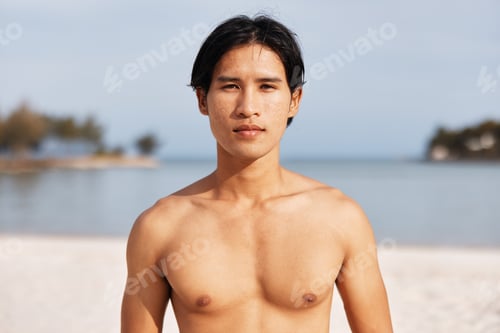 Preview: Muscular Asian Athlete Experiencing the Freedom of Running on the Beach at Sunset