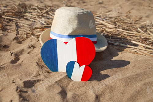 Preview: wooden heart straw hat with ribbon with color of flag of France blue white red in gold sand on beach