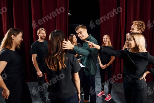Preview: Group of actors in dark colored clothes on rehearsal in the theater