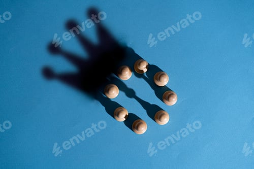 Preview: the abstract concept, chess pawns make a shadow of queen or king crown