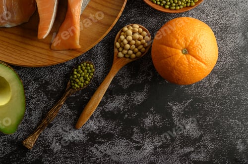 Preview: Legumes, fruit and salmon pieces on a wooden plate.