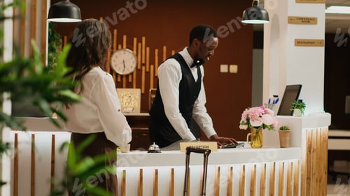 Preview: Woman ringing service bell at reception