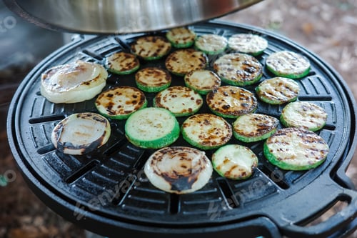Preview: Top view of fresh grilled zucchini and onion slices with char marks
