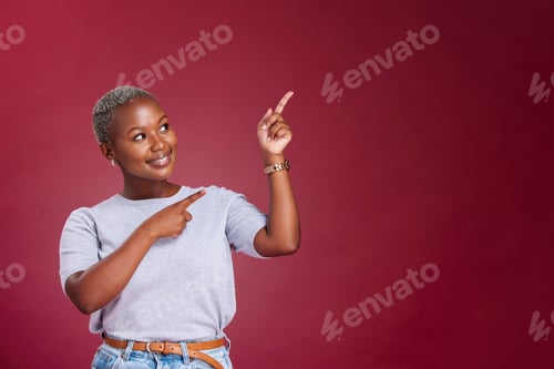 Preview: Black woman, mockup and pointing for advertising, marketing or banner against a studio background.