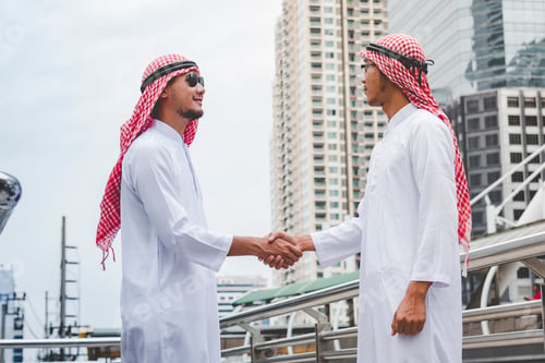 Preview: Arab Businessman shaking hands together. Teamwork business partner wear Muslim dress Shake Hands