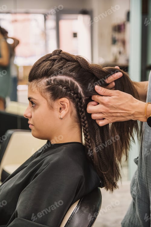 Preview: Woman receiving professional hair styling with braids